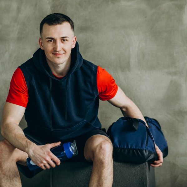 Young handsome man in sportswear at the gym