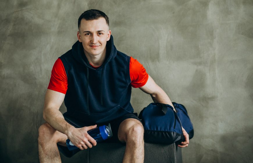 Young handsome man in sportswear at the gym
